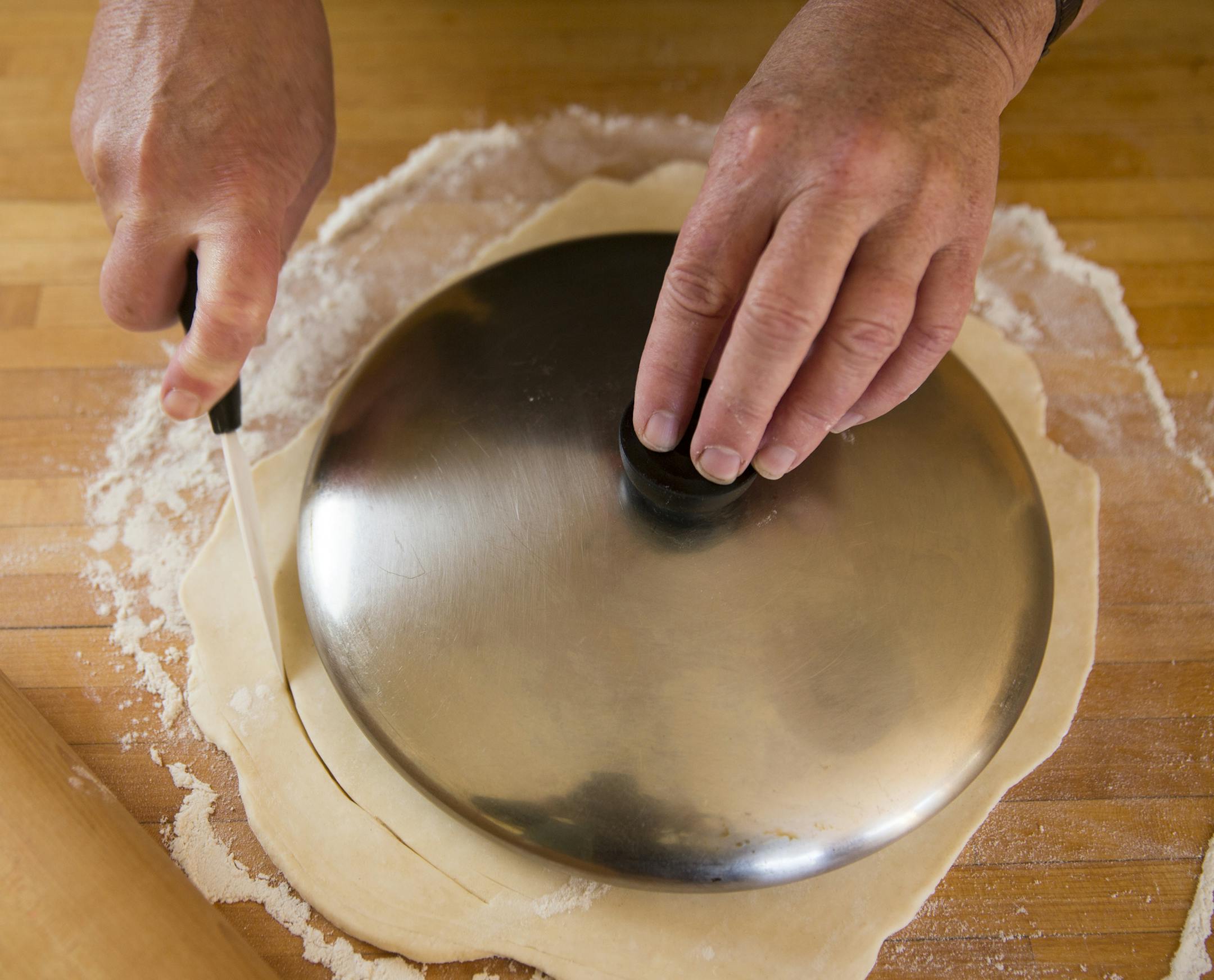 Cut the dough to fit the shape of the pan. Baking Central makes Apple Tarte Tatin. ] (Leila Navidi/Star Tribune) leila.navidi@startribune.com BACKGROUND INFORMATION: Baking Central makes Tarte Tatin for apple season, with an easy, flaky pastry on Thursday, October 13, 2016.