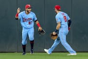 Gilberto Celestino (67) and Jake Cave (8) of the Minnesota Twins celebrate at the end of the game.
