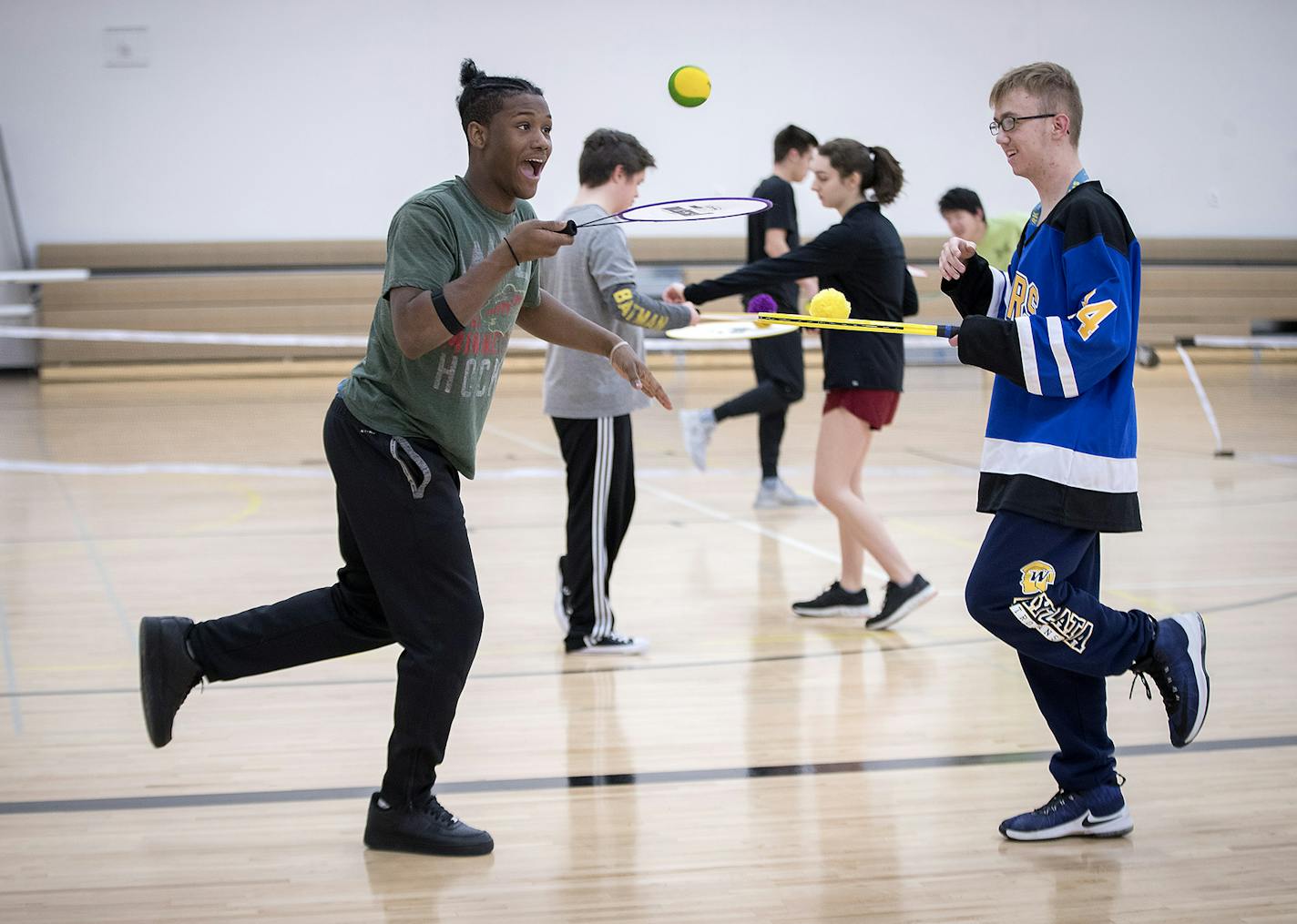 Wayzata senior Ra'king Skelton-Wilson, left, ran through tennis drills with Jagger Zoller during Unified PE at Wayzata High School, Thursday, January 18, 2018 in Plymouth, MN. Wayzata is in its second year of a wildly successful program called Unified PE, which brings together general students with special needs students in the same physical education class. It's so popular that the class fills up fast and they've developed a Unified club program after school. ] ELIZABETH FLORES &#xef; liz.flore