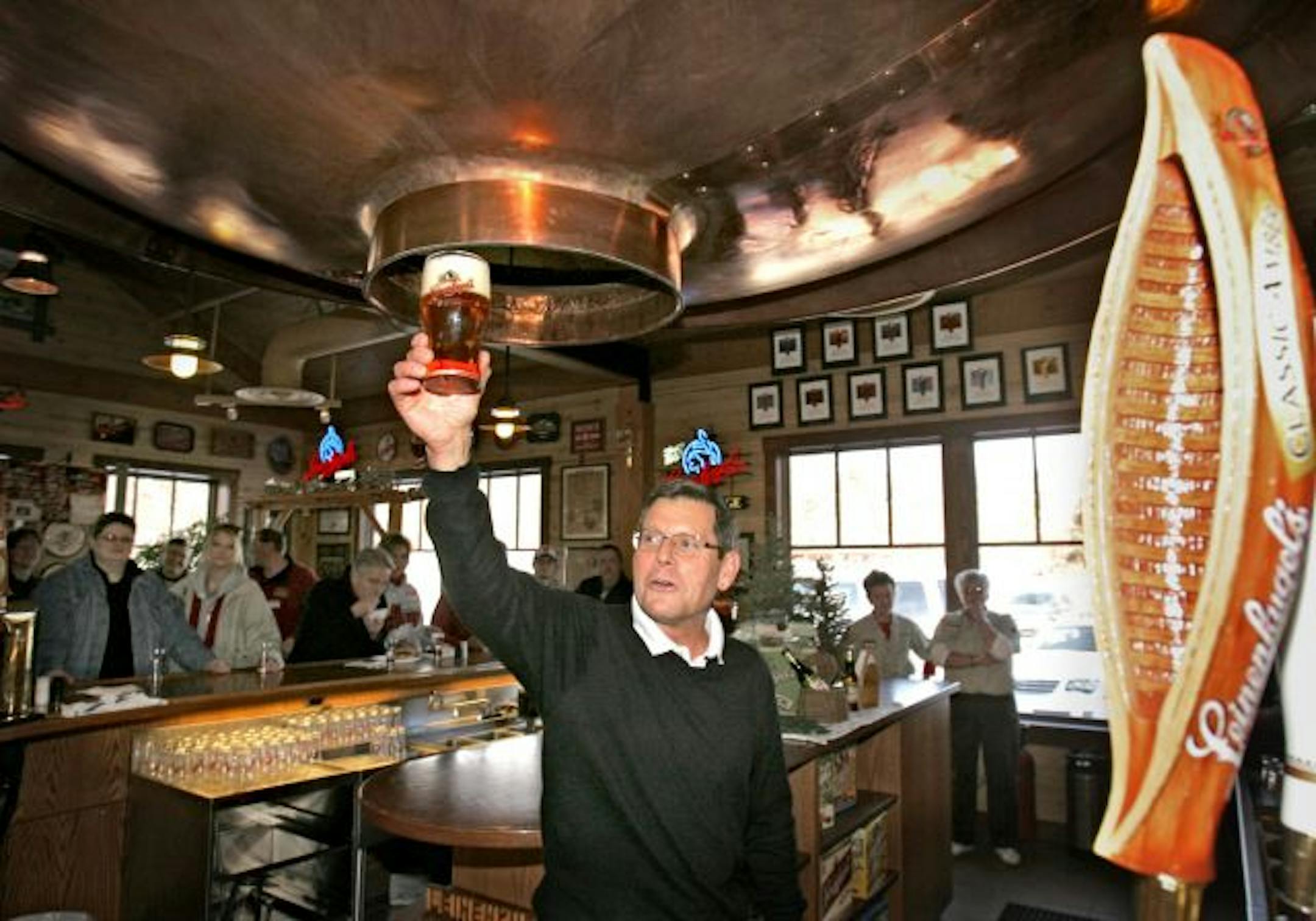 Jake Leinenkugel raises his glass of Leinenkugel's Classic Amber.