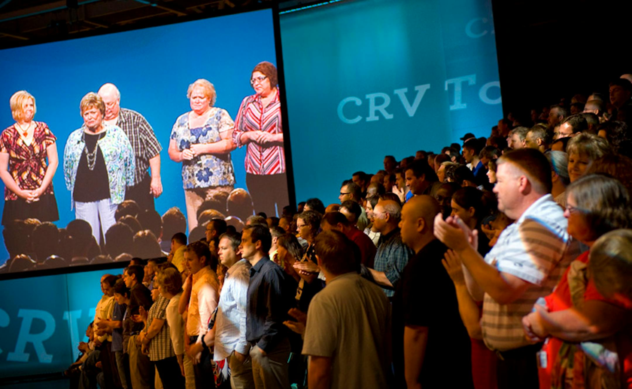 Sharon Knapp of Rogers, on screen, came to the Boston Sci meeting with her family to thank the employees for saving her life with their products.