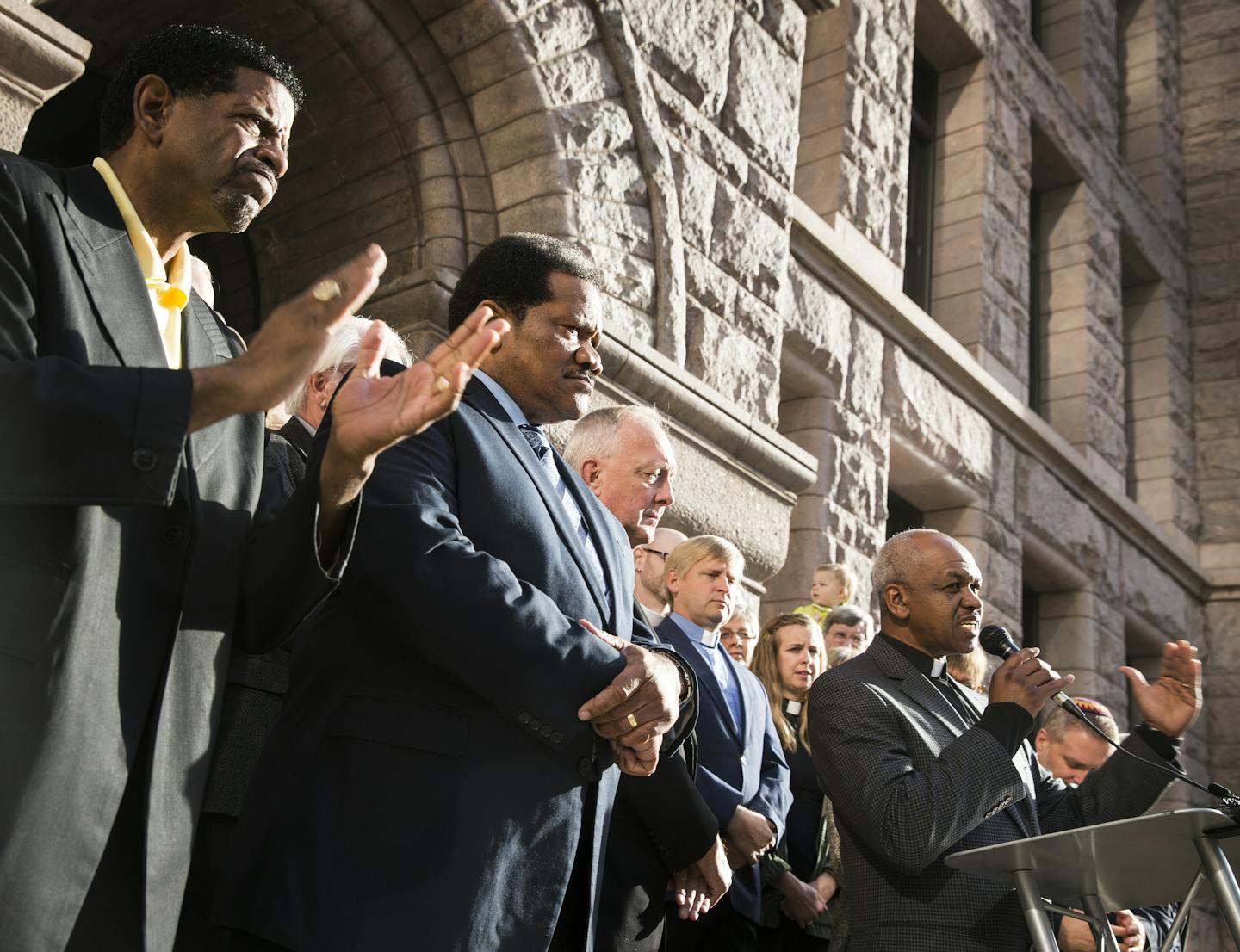 Rev. Paul Slack, right, of New Creation Church in Minneapolis, speaks in support of the proposed sick-leave ordinance with other clergy including Bishop Richard Howell, Jr., from left, of Shiloh Temple International Ministries of Minneapolis and Rev. Billy Russell of Greater Friendship Baptist Church in Minneapolis, outside City Hall in Minneapolis on Thursday, October 22, 2015. ] (LEILA NAVIDI/STAR TRIBUNE) leila.navidi@startribune.com BACKGROUND INFORMATION: Religious leaders gathered at Minne