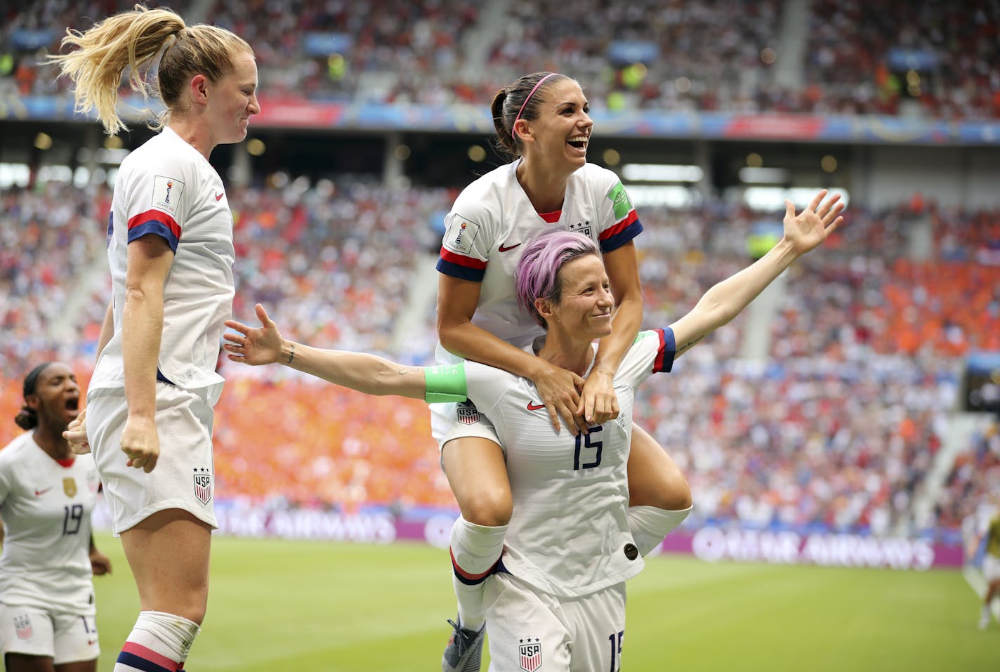 United States' Megan Rapinoe (15) and teammates celebrate after Rapinoe scored the opening goal from the penalty spot during the Women's World Cup final soccer match between U.S. and The Netherlands at the Stade de Lyon in Decines, outside Lyon, France, Sunday, July 7, 2019. (AP Photo/Francisco Seco)