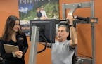 Amy Hudson, who with her husband opened up a second Exercise Coach location in October, works with customer Bruce Johnson on a high-tech smart fitness