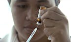 FILE - In this file image made from Nov. 25, 2019, file video, a New Zealand health official prepares a measles vaccination at a clinic in Apia, Samoa