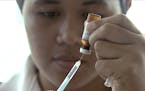 FILE - In this file image made from Nov. 25, 2019, file video, a New Zealand health official prepares a measles vaccination at a clinic in Apia, Samoa