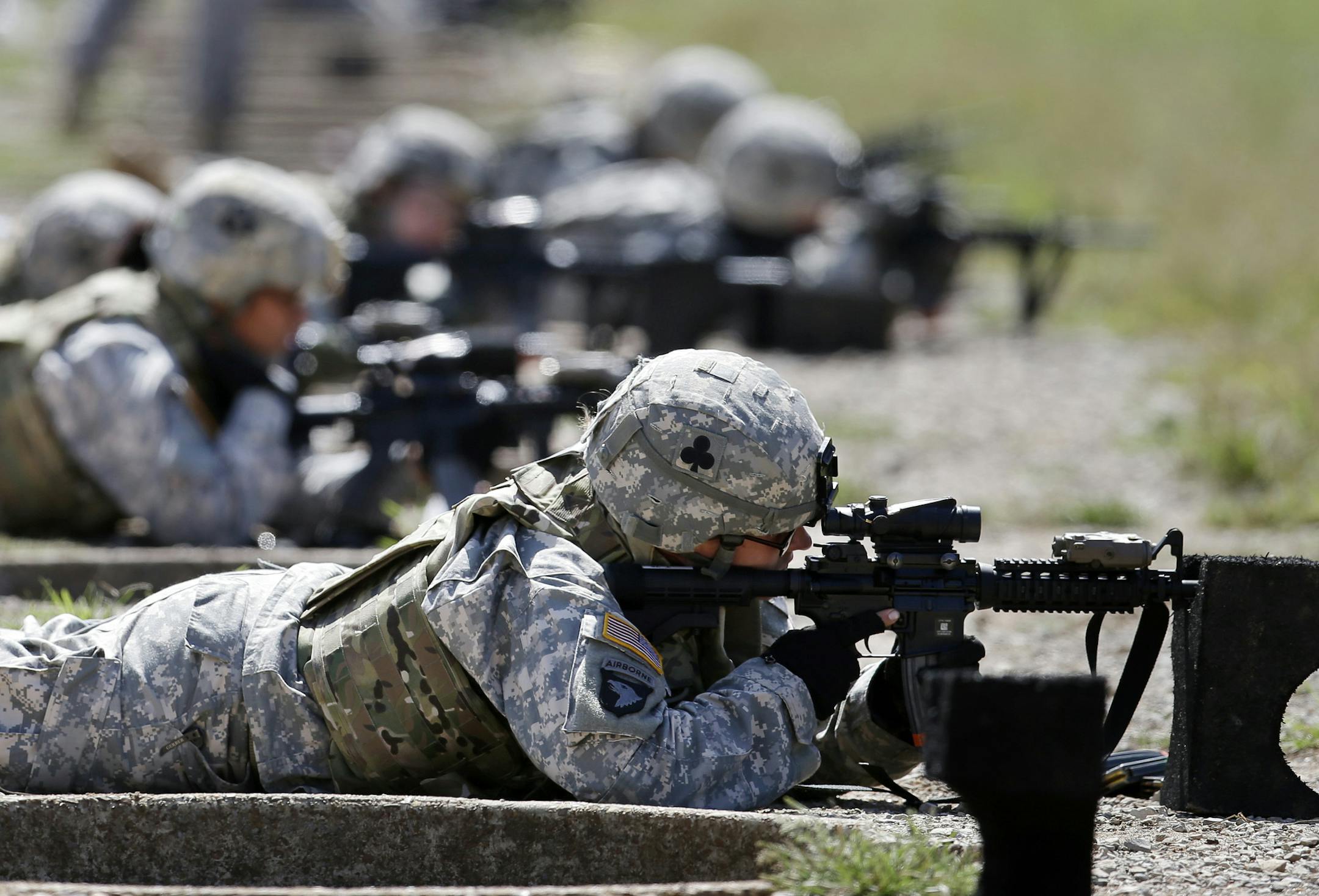 FILE - In this Sept. 18, 2012 file photo, female soldiers from 1st Brigade Combat Team, 101st Airborne Division train on a firing range while testing new body armor in Fort Campbell, Ky. Congress is on the verge of ordering young women to register for a military draft for the first time in history, touching off outrage among social conservatives who fear the move is another step toward blurring gender lines. (AP Photo/Mark Humphrey, File)