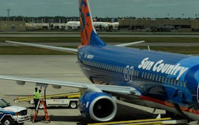 GLEN STUBBE � gstubbe@startribune.com Tuesday, July 10, 2007 -- Bloomington, Minn. -- A Sun Country Airlines Boeing 737-800 is fueled on the tarmac
