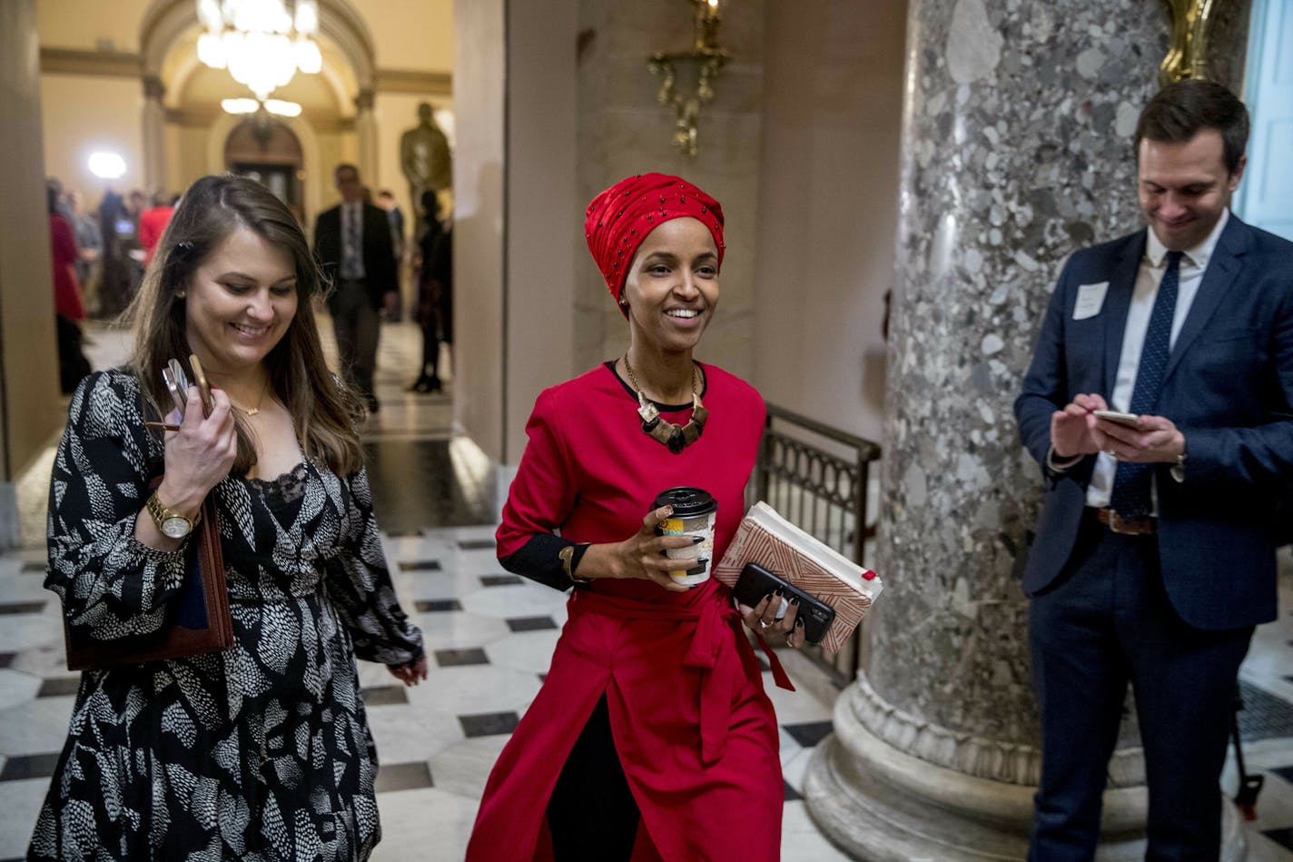 Rep. Ilhan Omar, D-Minn., center, walks through the halls of the Capitol Building in Washington, Wednesday, Jan. 16, 2019. (AP Photo/Andrew Harnik)