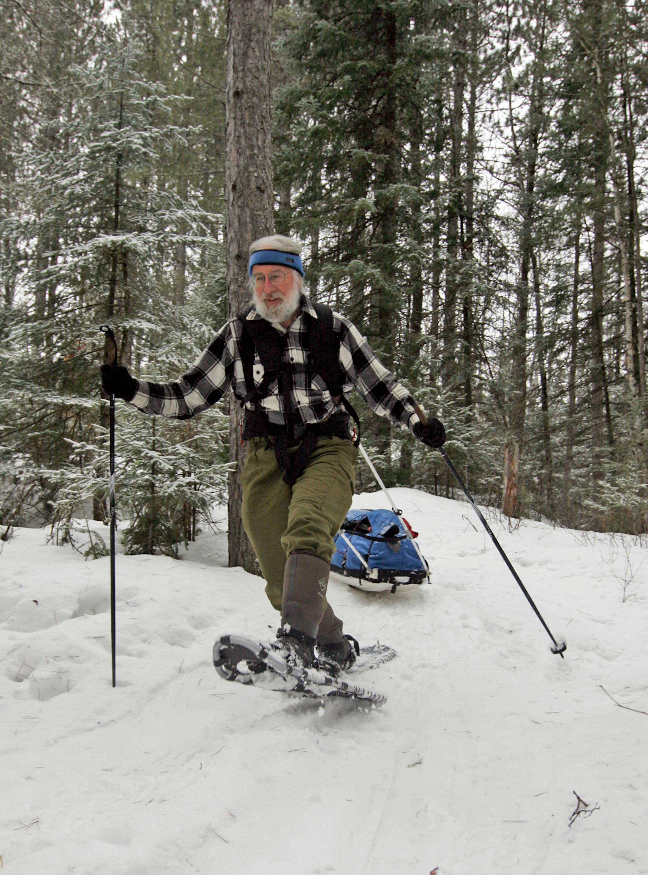 Gary Thornbloom navigates a hill pulling an 80-pound sled of gear through the woods in the Boundary Waters Canoe Area Wilderness. Thornbloom, who lives in Pennslyvania, has paddled the BWCA in the summer but wanted to try winter camping in the million-acre wilderness in northern Minnesota. Doug Smith/Star Tribune.