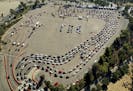 FILE - In this Nov. 17, 2020, file photo, drivers wait in long lines at a COVID-19 testing site in a parking lot at Dodger Stadium in Los Angeles. The