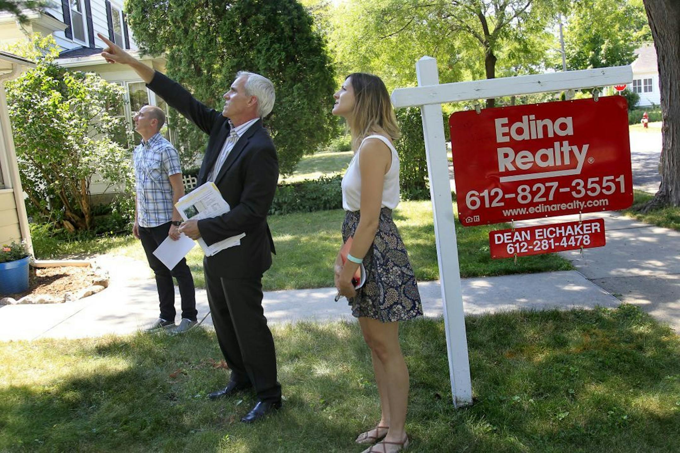 Realtor, Arlo Dissette, center, showed a home to Tom and Ashlee Cermak in Minneapolis, Wednesday, July 11, 2012. The Minneapolis Area Association of Realtors will release the June home sales figures on Thursday. We expect double-digit increases in sales and prices. (ELIZABETH FLORES/STAR TRIBUNE) ELIZABETH FLORES � eflores@startribune.com