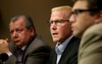 St. Paul Central High teacher John Eklbad, center, speaks to media members Tuesday, Dec. 22, 2015, at his attorneys' Bloomington MN, office, recountin