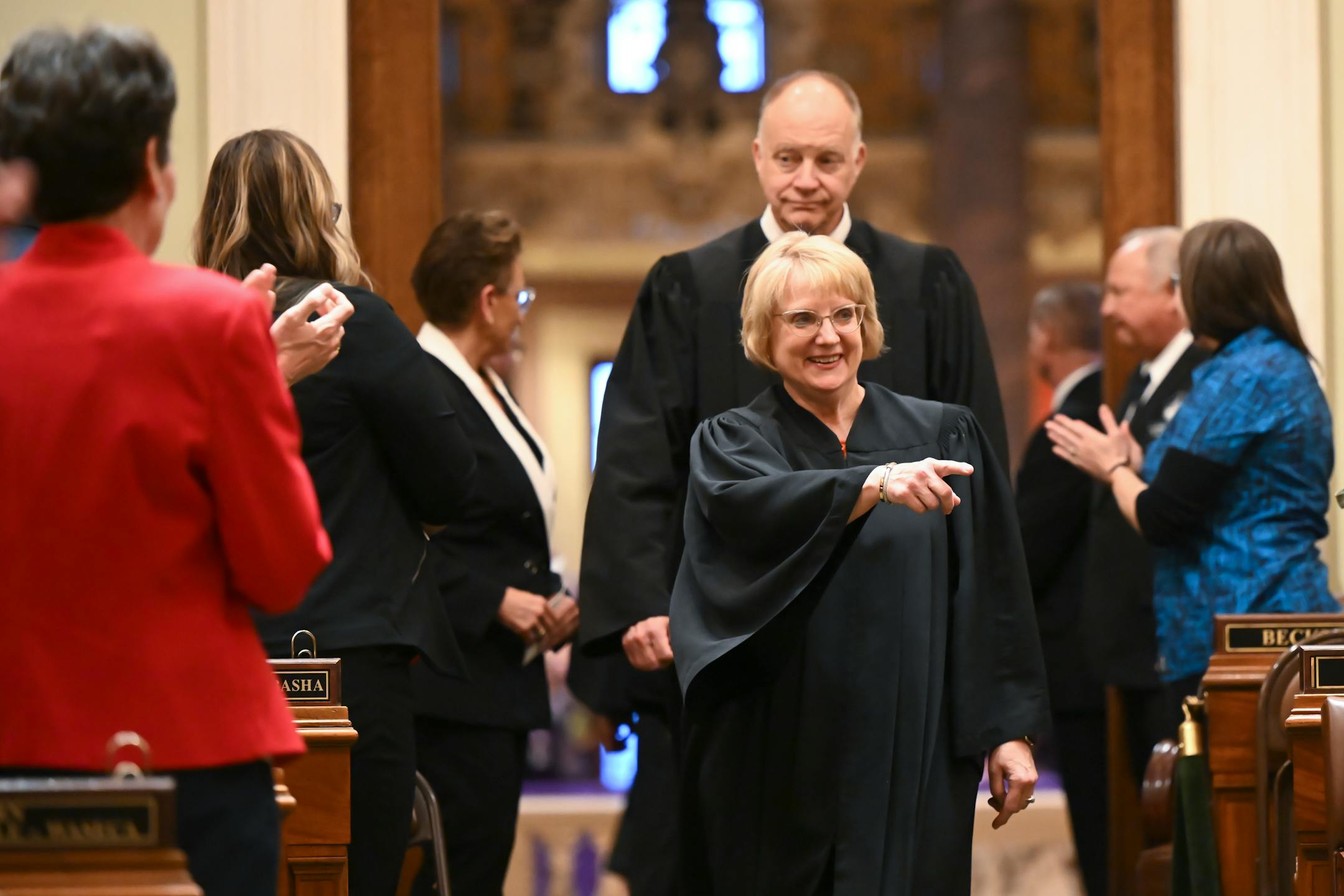Minnesota Supreme Court Chief Justice Lorie Skjerven Gildea and Associate Justice Barry Anderson enter the house chambers before the start of the State of the State address.