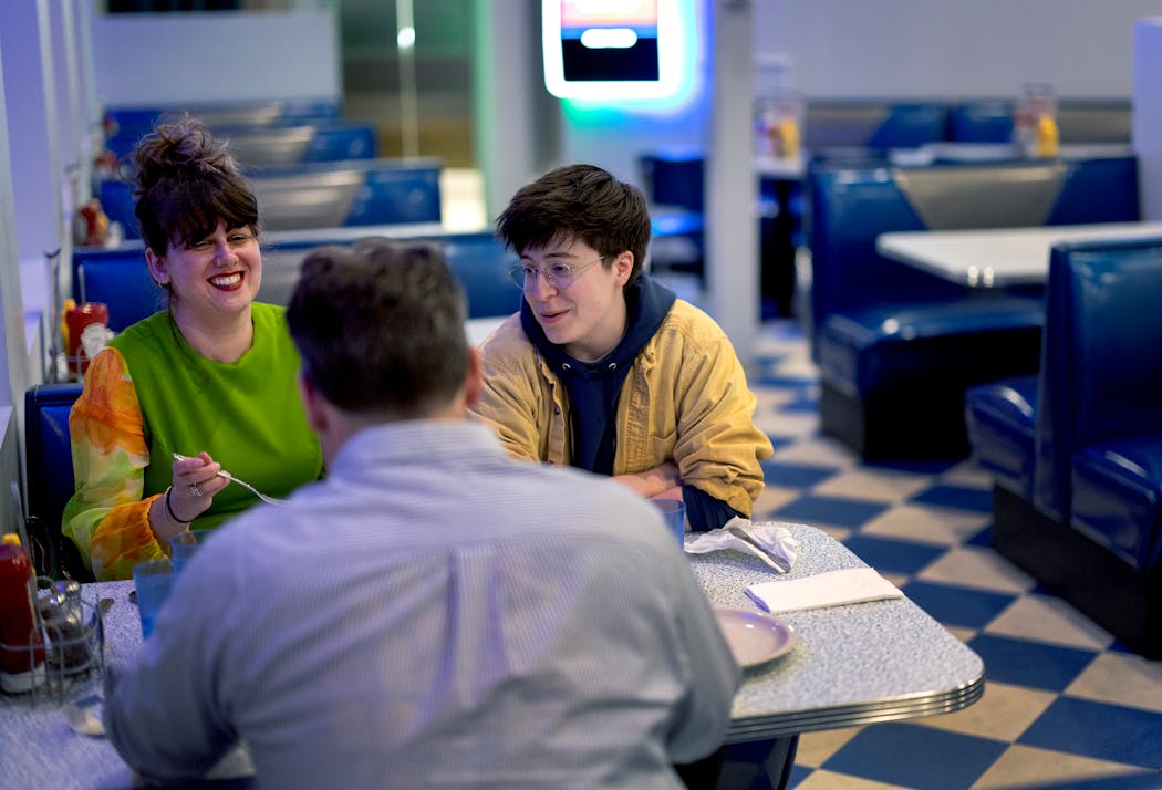 Sydney VanTassel, Dustin Bowman and Rebecca Williams, all of Vermont, chat during a meal at the Nicollet Diner in Minneapolis on April 24.