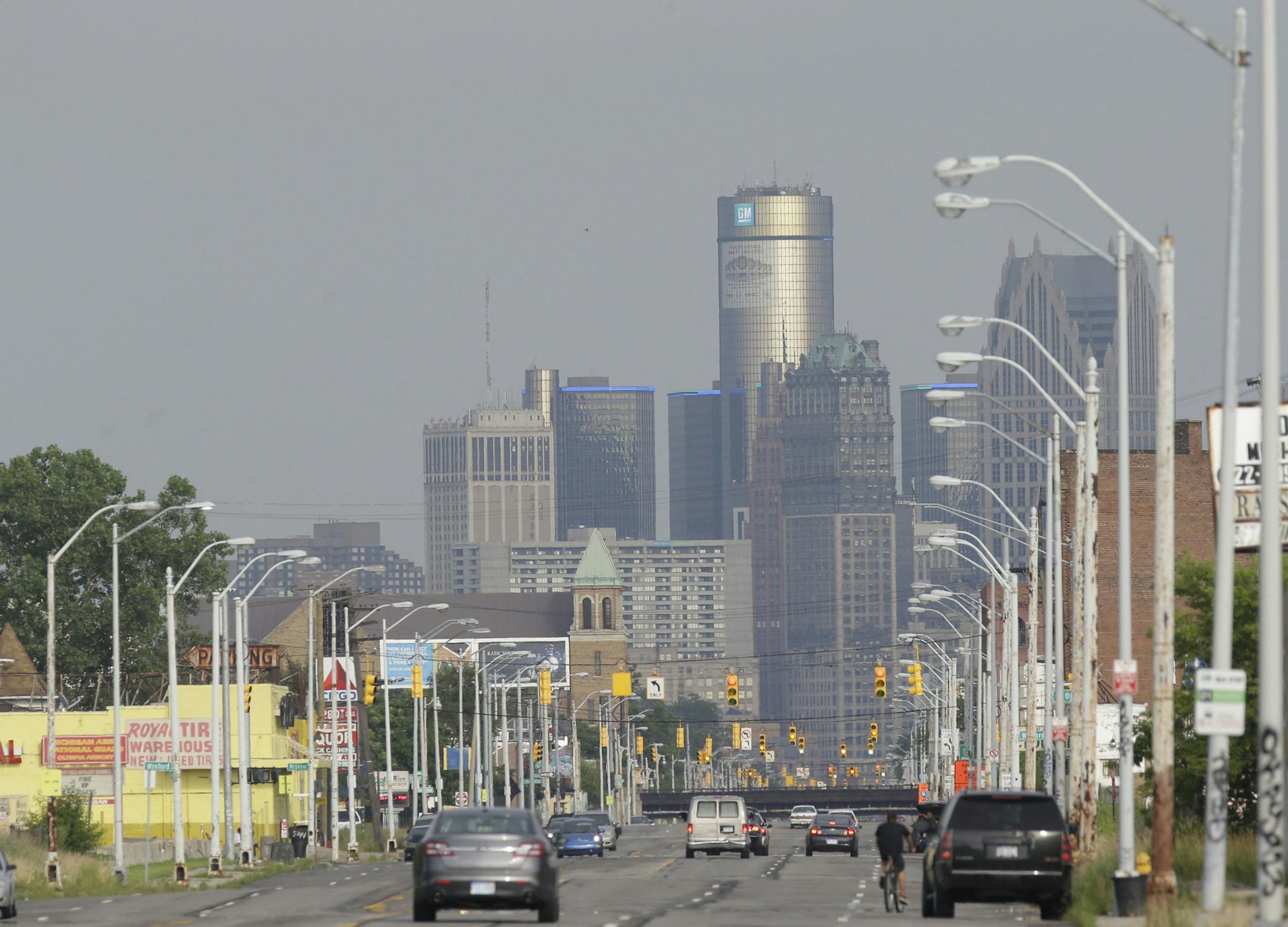 FILE - This July 18, 2013 file photo shows the Detroit skyline as seen from Grand River on Thursday, July 18, 2013, in Detroit. Four years ago, America&#xed;s Big Three automakers mortgaged all they owned or went into bankruptcy court to keep from going broke. Since then, General Motors, Chrysler and Ford have all returned to full financial health, unlike Detroit itself, which filed for bankruptcy Thursday after years of painful decline. (AP Photo/Carlos Osorio, File) ORG XMIT: MIN20130725210053