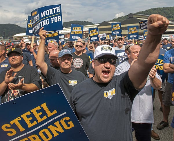 Tom Duffy of Clairton raises his fist as hundreds of United Steelworkers rally and march on Thursday, Aug. 30, 2018, in Clairton, Pa. U.S. Steel's con