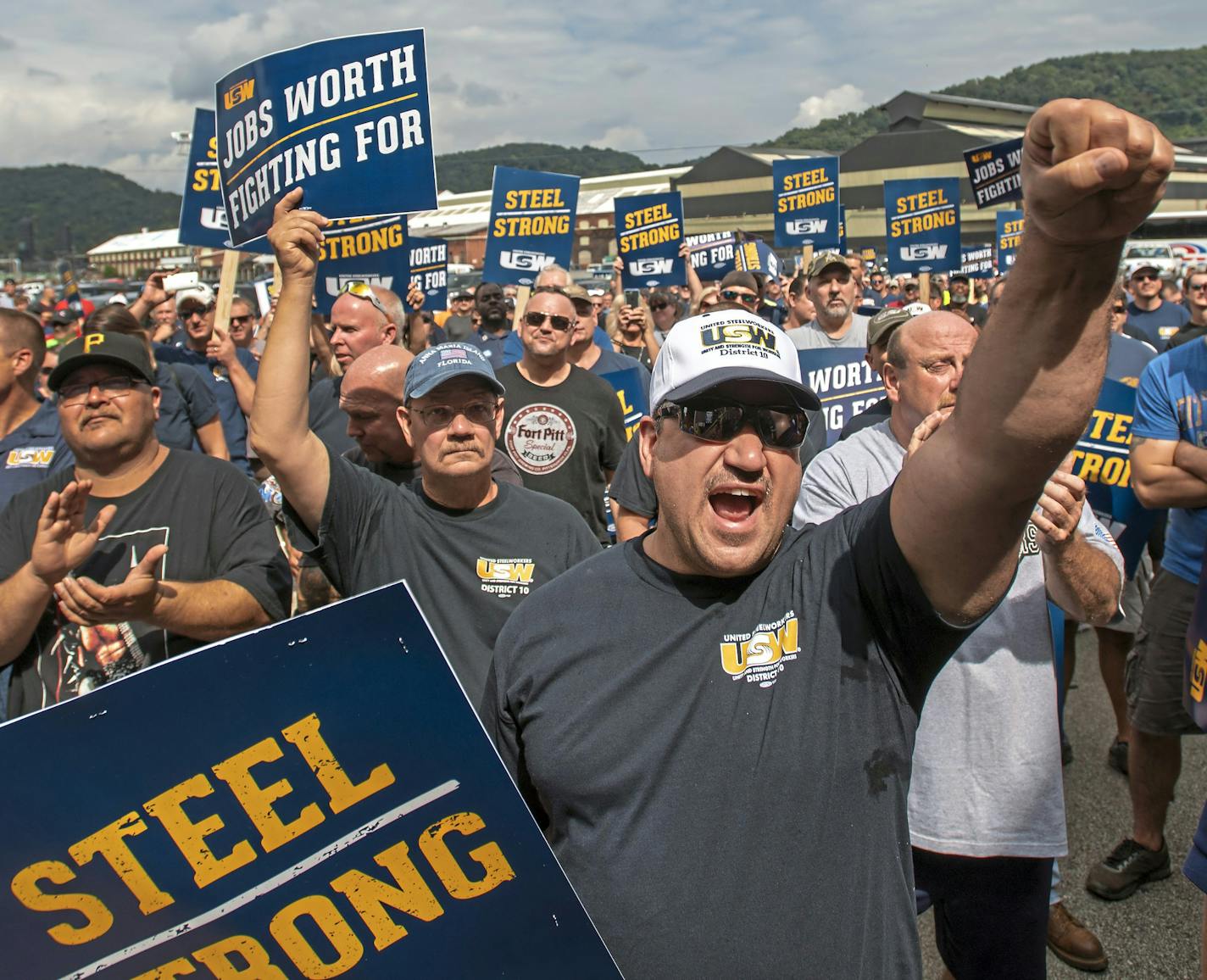 Tom Duffy of Clairton raises his fist as hundreds of United Steelworkers rally and march on Thursday, Aug. 30, 2018, in Clairton, Pa. U.S. Steel's contract with more than 16,000 members of the union expires at midnight Saturday. (Steph Chambers/Pittsburgh Post-Gazette via AP)