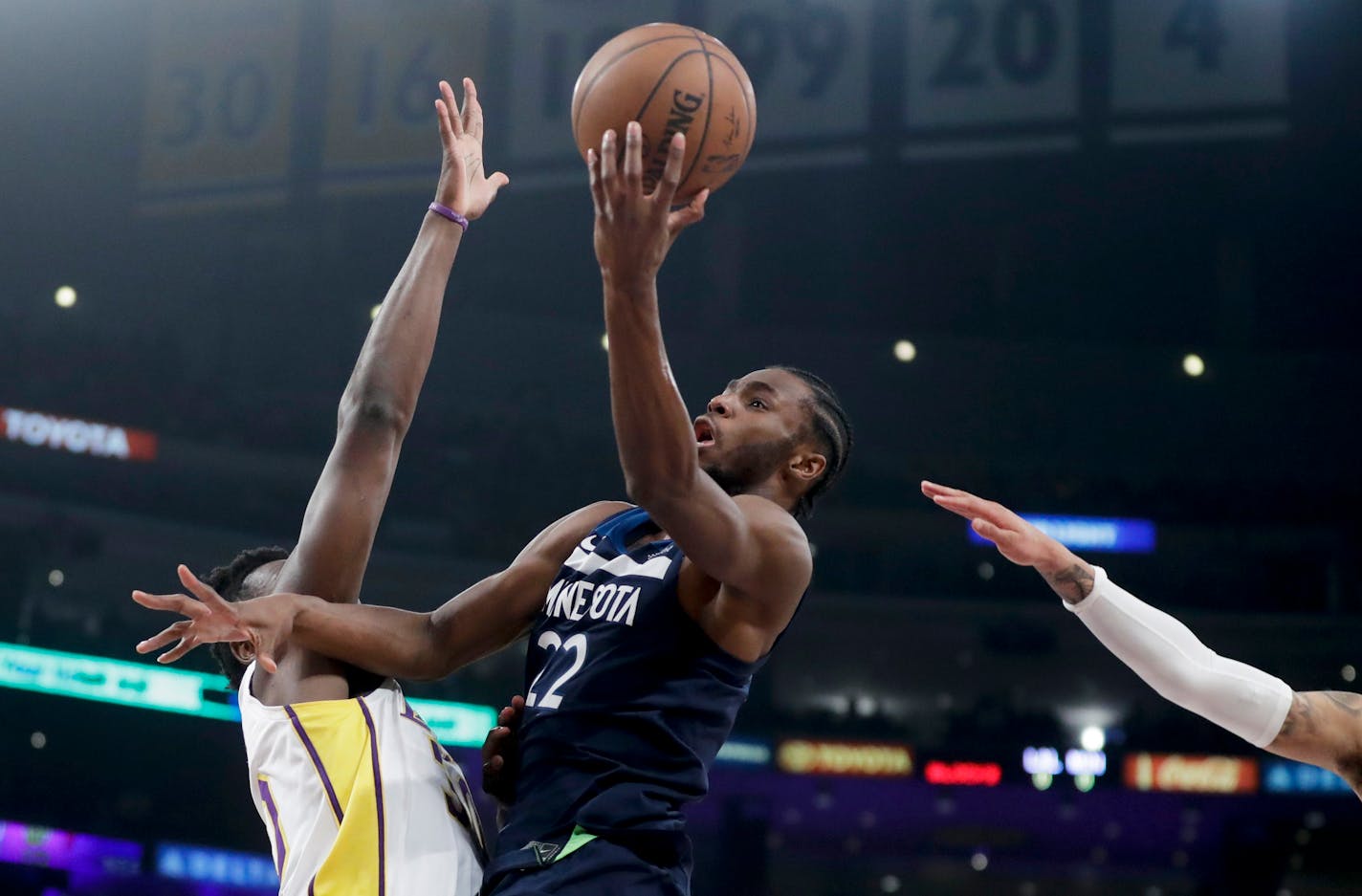 Minnesota Timberwolves forward Andrew Wiggins, right, shoots over Los Angeles Lakers forward Julius Randle during the first half of an NBA basketball game in Los Angeles, Monday, Dec. 25, 2017. (AP Photo/Chris Carlson)