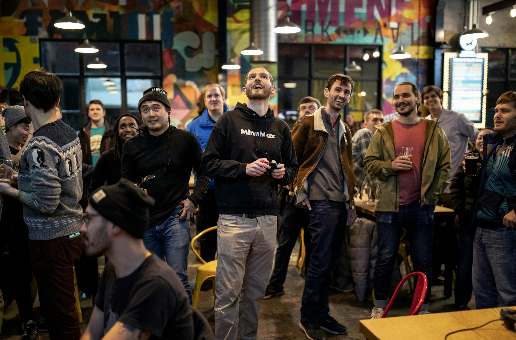 Ben Hanson (middle) set up a game for tournament players. Hanson of MinnMax hosted a game night at Bauhaus Brew Labs in Minneapolis.