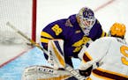 Minnesota State goaltender Dryden McKay, back, looks to stop a shot off the stick of Minnesota forward Sammy Walker in the third period of an NCAA Col