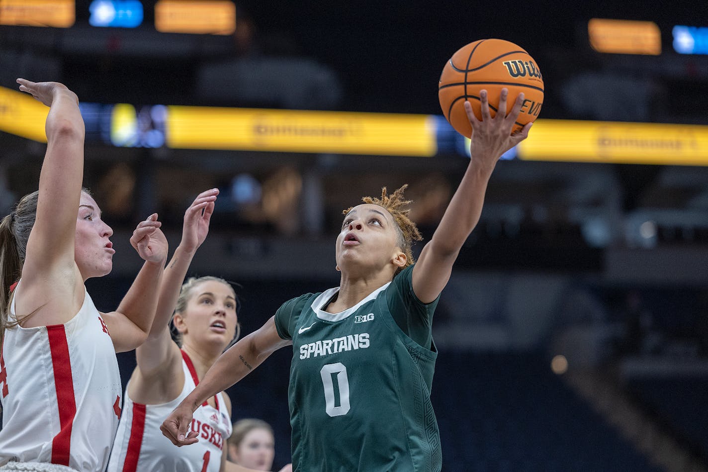 Michigan State's guard DeeDee Hagemann (0) drives for two and draws a foul from Nebraska's forward Isabelle Bourne, left, during the third quarter of an NCAA college basketball game in the Big Ten conference women's tournament on Thursday, March 2, 2023 at Target Center in Minneapolis, Minn. (Elizabeth Flores/Star Tribune via AP)