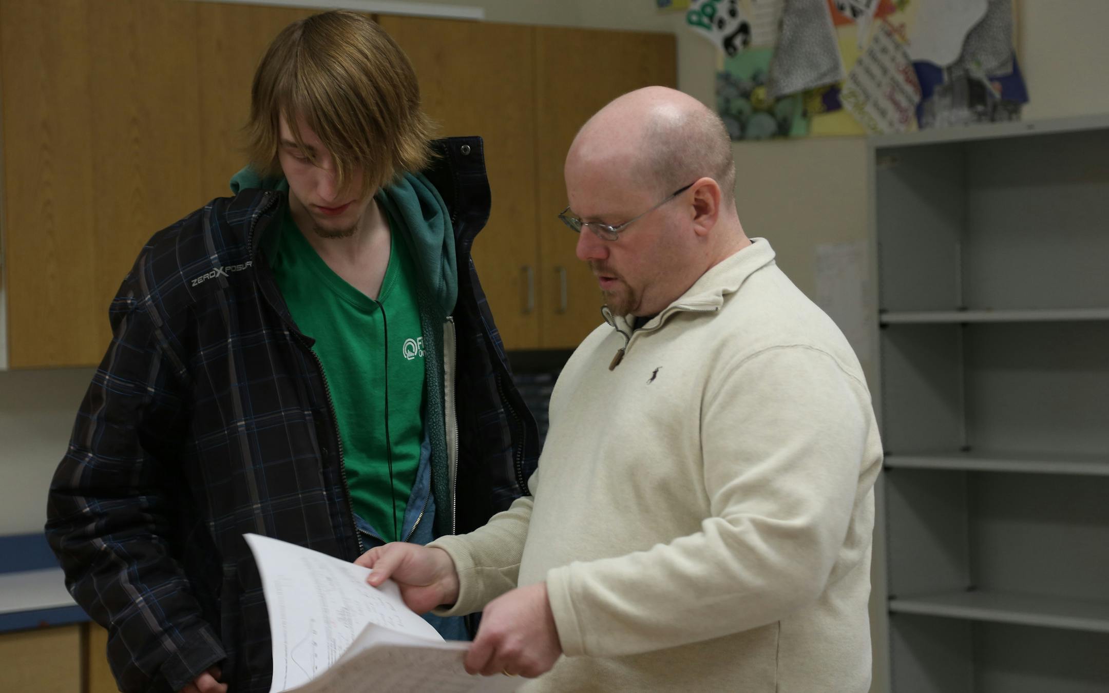 Neil Boguss, left,listened as teacher Mark Duffy explained his tasks in statistics class. ] (KYNDELL HARKNESS/STAR TRIBUNE) kyndell.harkness@startribune.com Crossroads West High School in Champlin Min., Thursday, March 5, 2015.