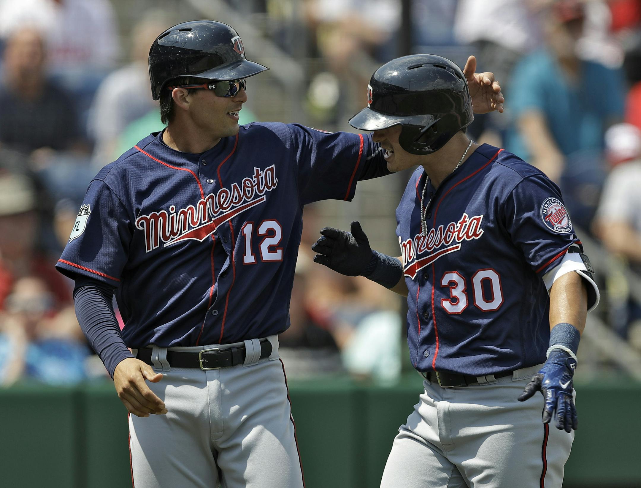 Minnesota Twins' Tommy Field (30) celebrates with John Ryan Murphy (12) after Field hit a two-run home run off Philadelphia Phillies starting pitcher Aaron Nola during the third inning of a spring training baseball game Thursday, March 23, 2017, in Clearwater, Fla. (AP Photo/Chris O'Meara)