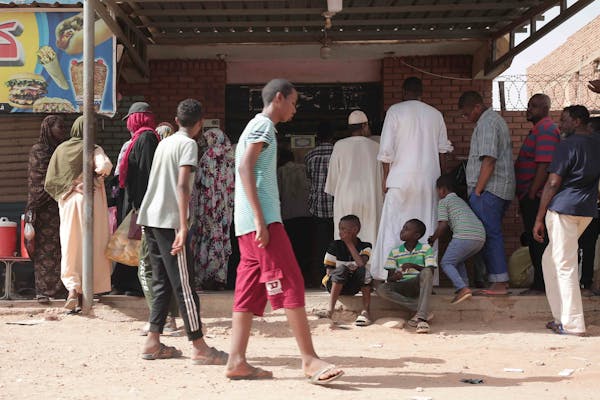 People line up in front of a bakery during a cease-fire in Khartoum, Sudan, Saturday, May 27, 2023.