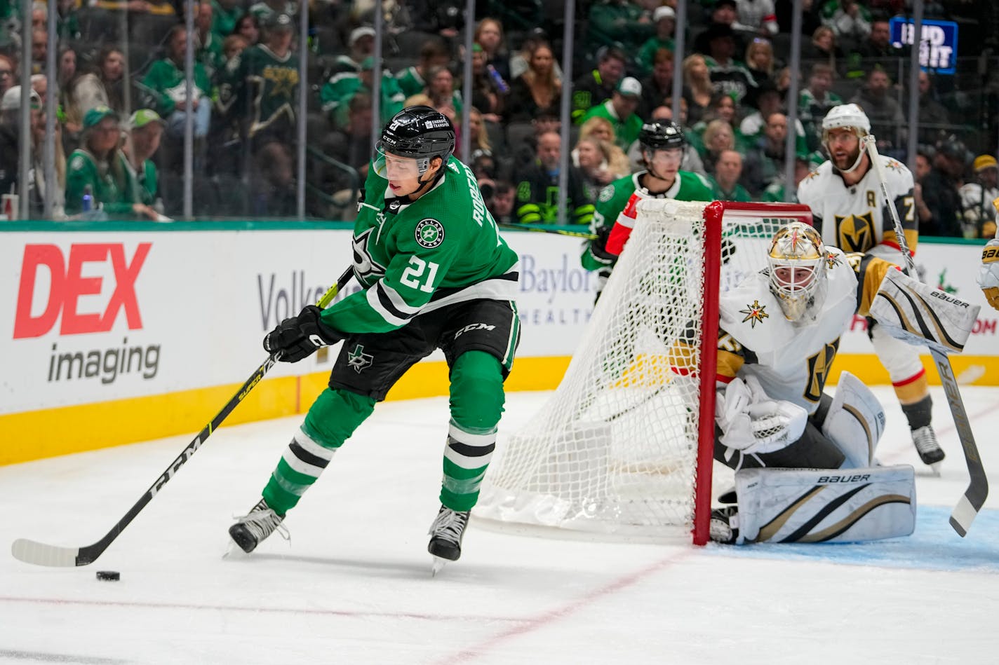 Dallas Stars left wing Jason Robertson (21) skates with the puck as Vegas Golden Knights goaltender Logan Thompson defends his net during the first period of an NHL hockey game, Saturday, Dec. 9, 2023, in Dallas. (AP Photo/Julio Cortez)