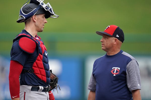 Minnesota Twins catcher Jason Castro (15) talked with pitching coach Wes Johnson