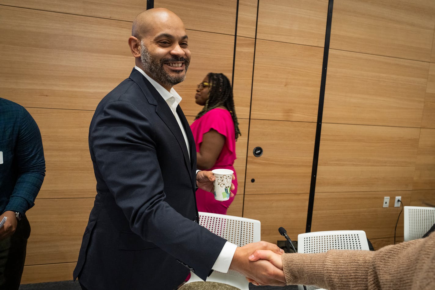 Newly elected Council President Elliott Payne is shakes hands with someone off-camera during Minneapolis City Council's first meeting of 2024 in Minneapolis, Minn. Monday, Jan. 8, 2024.