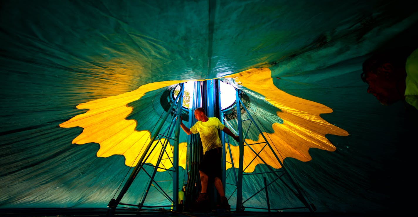 Stoney Adcock from Myers Entertainment helped raise the roof of the Wave Swinger ride at the Fair. The opening of the 2014 Minnesota State Fair is less than a week away and the place is hopping. ] Thursday, August 14, 2014. GLEN STUBBE * gstubbe@startribune.com