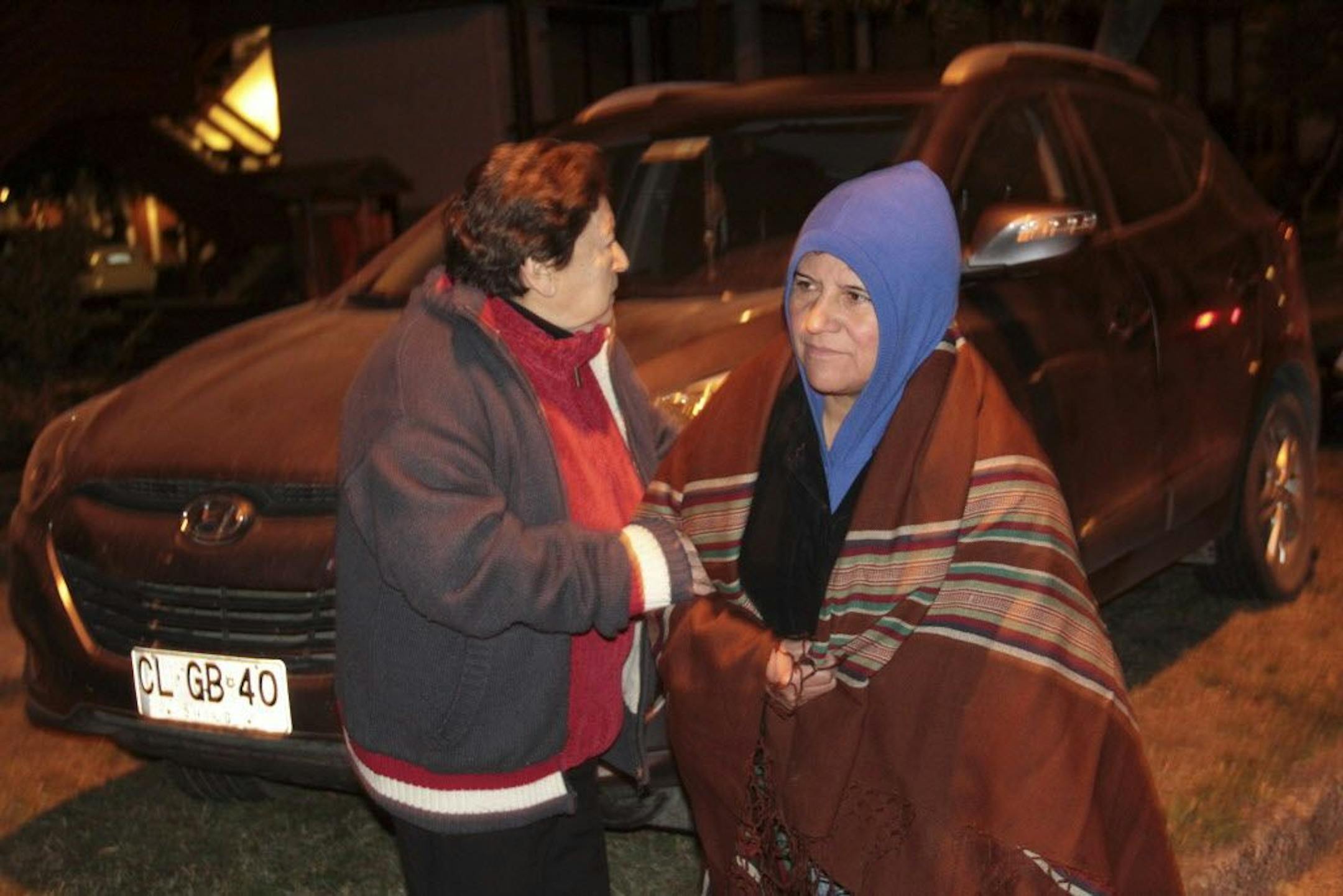 People leave their houses after Villarica volcano erupted near Pucon, Chile, early Tuesday, March 3 , 2015.