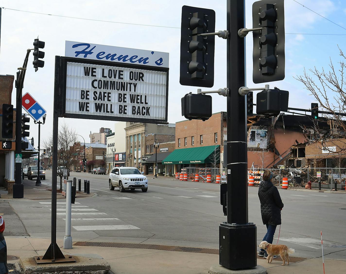 A sign along the main drag in downtown Alexandria, MN Thursday, April 2, 2020, addresses the Coronavirus pandemic as well as the recent disaster where a massive fire near the end of February destroyed several businesses on part of a block, the rubble seen visible across the street from the sign.