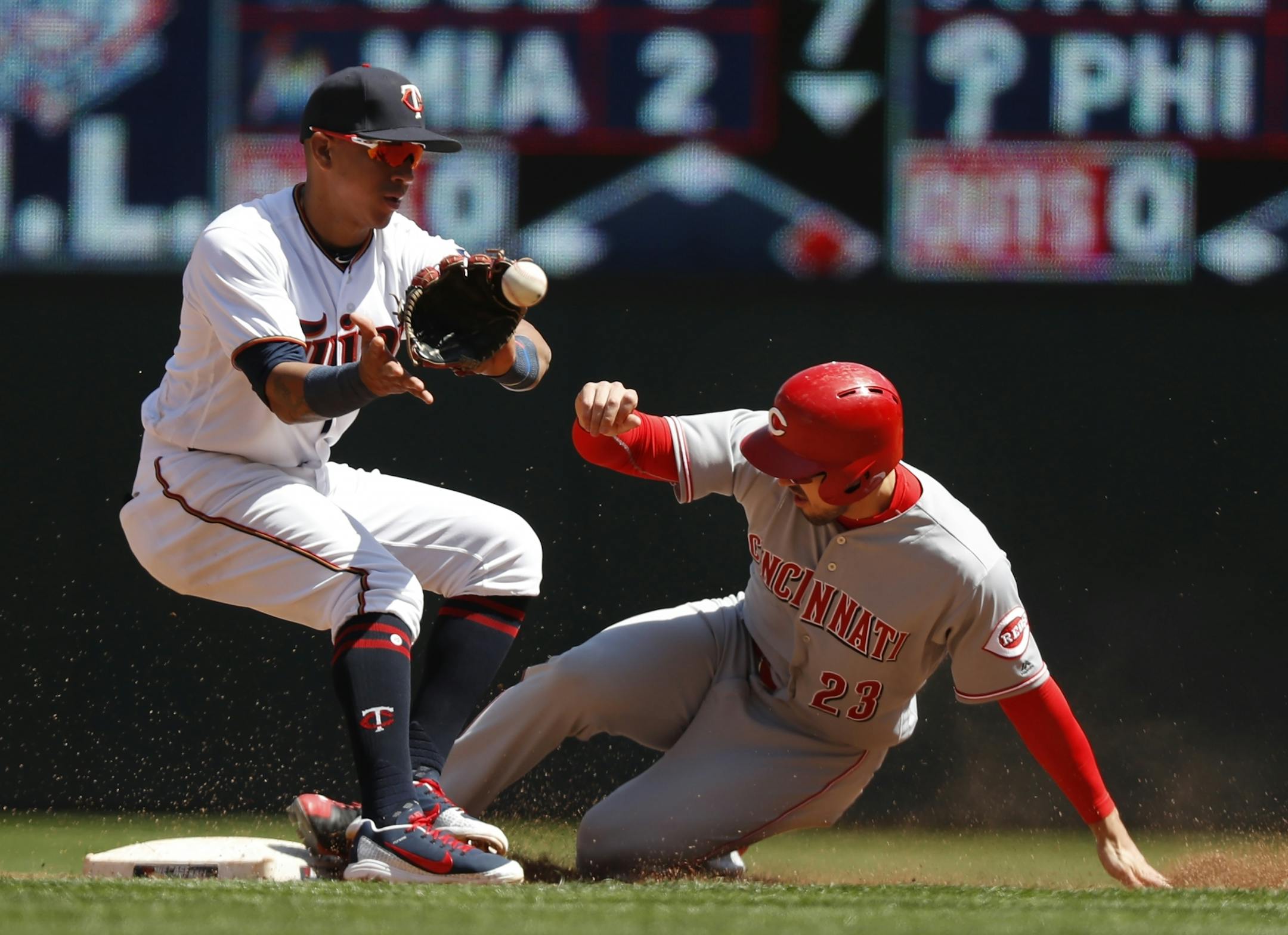 The Reds' Adam Duvall slid into second base with Twins shortstop Ehire Adrianza covering in the third inning Sunday.
