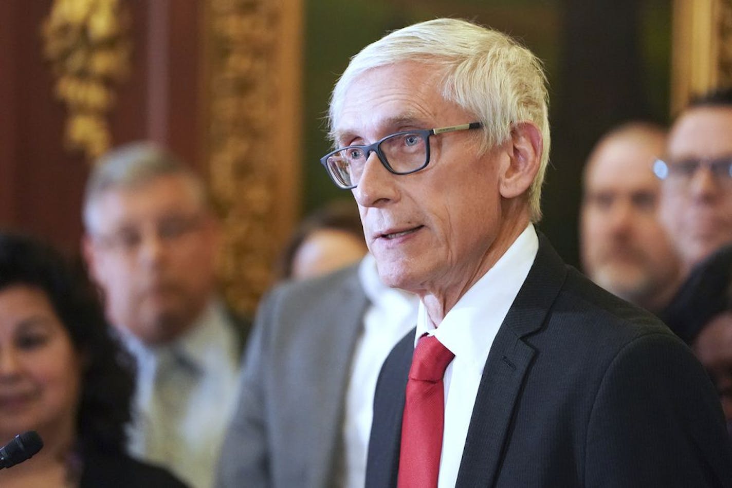 FILE - In this Thursday Feb. 6, 2020 file photo, Wisconsin Gov. Tony Evers holds a press conference in Madison, Wis. Wisconsin Gov. Tony Evers says he will order the closure of all non-essential businesses starting Tuesday, March 24, 2020, due to the coronavirus outbreak. He's also urging people to stay at home to slow the spread of the COVID-19 virus.