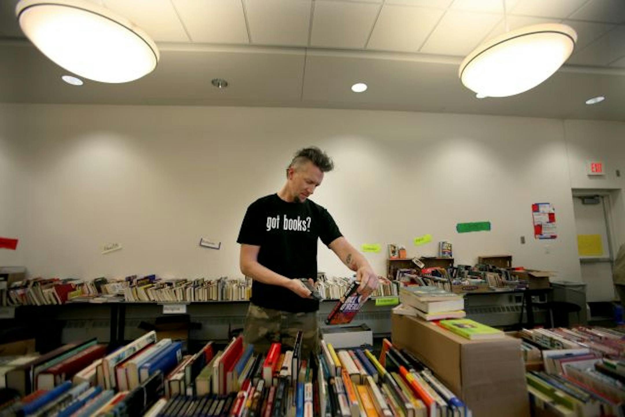 Peter Von Sien calls himself a book scout. He uses an electronic scanner to find valuable books at book sales and re-sells them on the internet. Here, Von Sien scanned books at the Eden Prairie Library benefit book sale Friday morning. Library volunteers are dealing with this new group of competitive book buyers who use scanners to get ahead of other buyers.