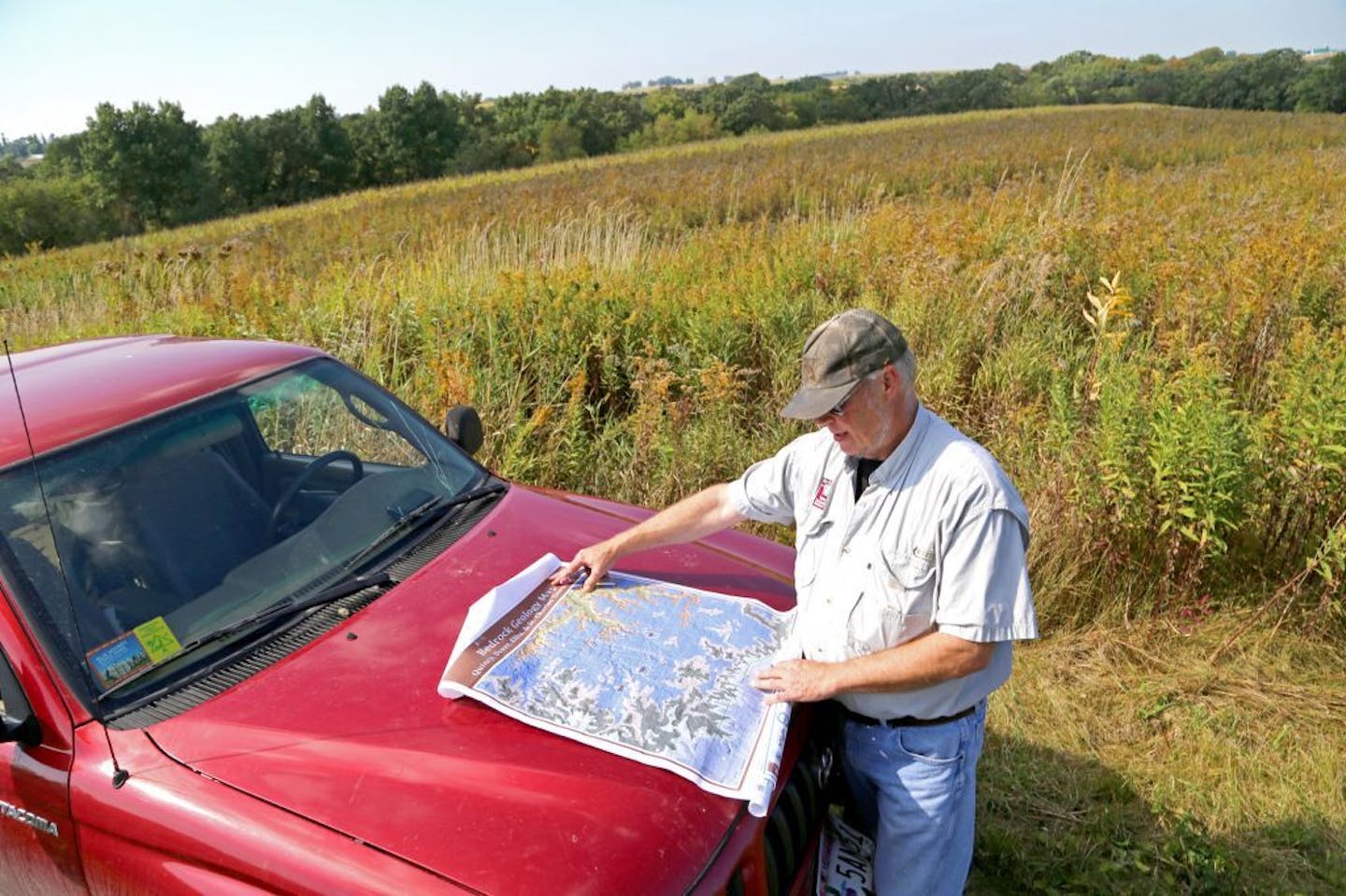 Jeff Broberg of rural St. Charles, Minn., in the southeast part of the state, on his farm, with a map showing the region's geology and it's particular susceptibility to nitrate groundwater polllution.