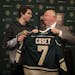 Minnesota Wild head coach Bruce Boudreau presented Carter Casey, 16, with a team sweater after he signed a one-day contract to the team.