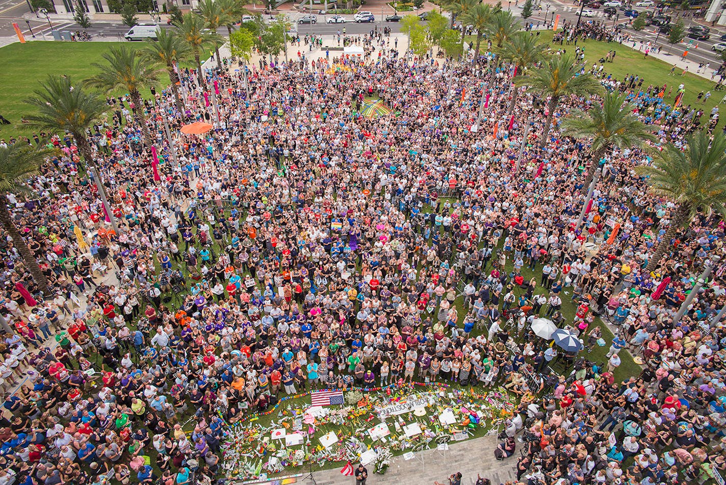 Mourners gather at a vigil for victims of the mass shooting at Pulse nightclub, outside the Dr. Phillips Center for the Performing Arts in Orlando, Fla., June 13, 2016. A gunman who pledged allegiance to the Islamic State killed 49 people and wounded 53 in the crowded gay nightclub in Orlando early Sunday. (Angel Franco/The New York Times)