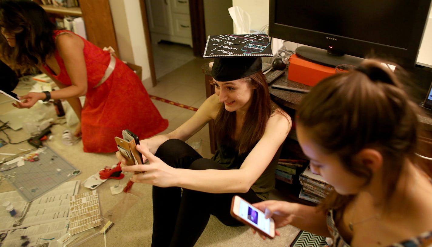 Hanna DeGroot took selfie in her newly decorated graduation cap to make sure she didn't want to add anything else. ] (KYNDELL HARKNESS/STAR TRIBUNE) kyndell.harkness@startribune.com A party at Hanna DeGroot's apartment, where she and some gal pals will be decorating their graduation caps in Minneapolis Min., Friday, May 8, 2015.