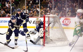 Edina forward Mason West looks to pass from behind the net during the first period Saturday.