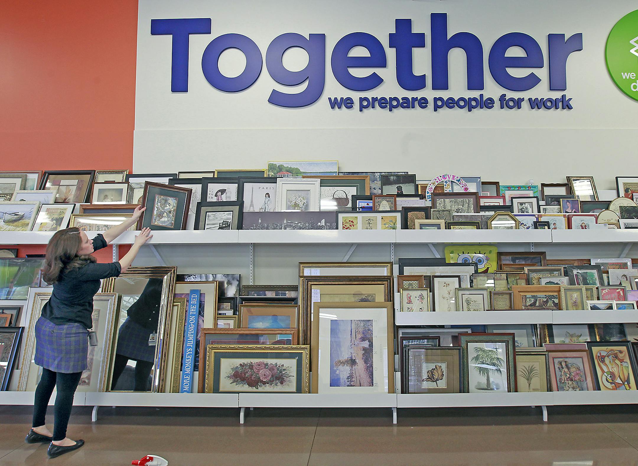 Amy Hanson stocked items at the new Goodwill, Friday, February 27, 2015 in St. Paul, MN. The Goodwill will open its new flagship store on University Avenue in St. Paul on Saturday. ] (ELIZABETH FLORES/STAR TRIBUNE) ELIZABETH FLORES • eflores@startribune.com