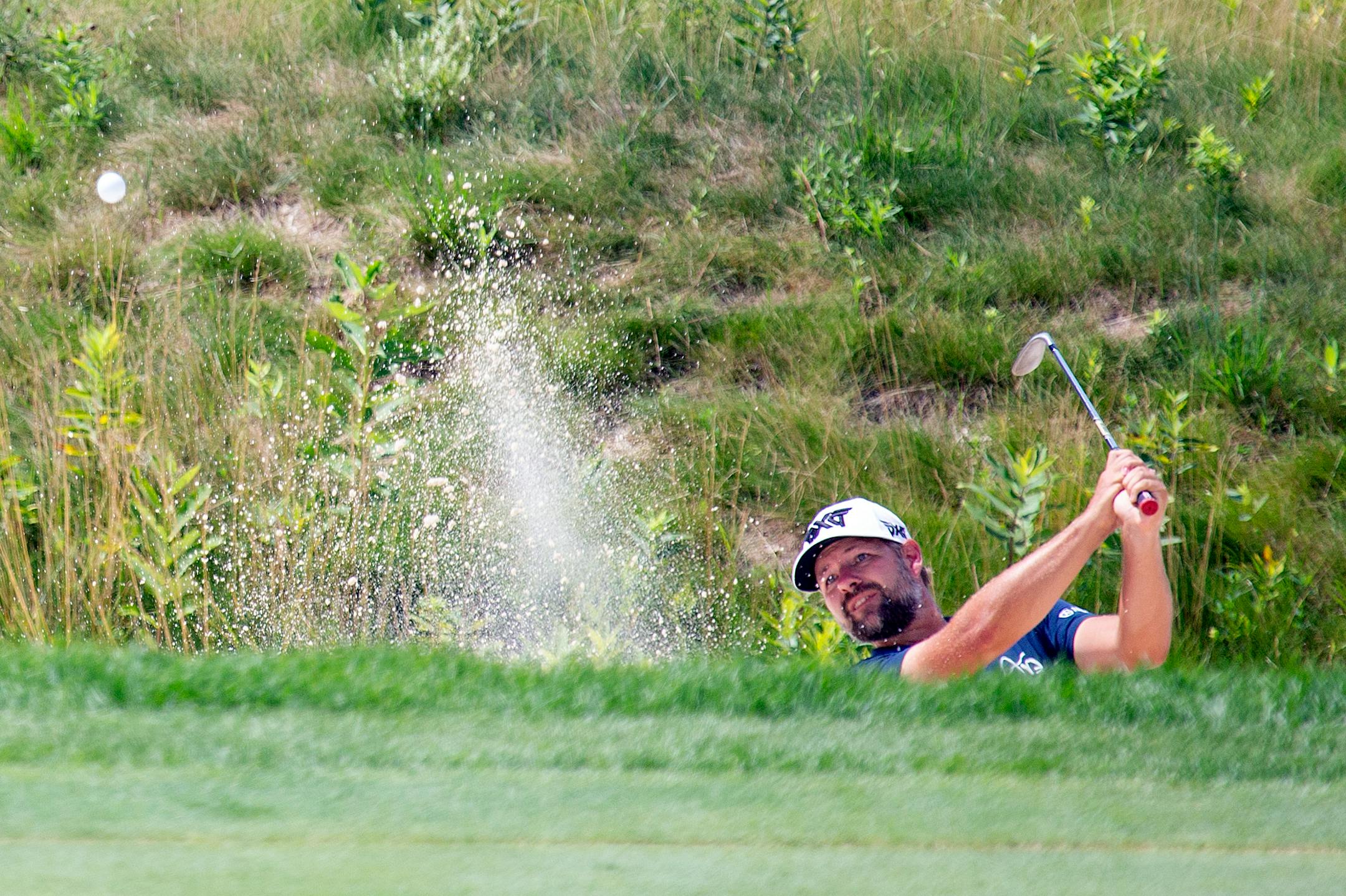 Ryan Moore hits out of a bunker on the 13th hole during the final round of the 3M Open golf tournament in Blaine, Minn., Sunday, July 26, 2020. (AP Photo/Andy Clayton- King)