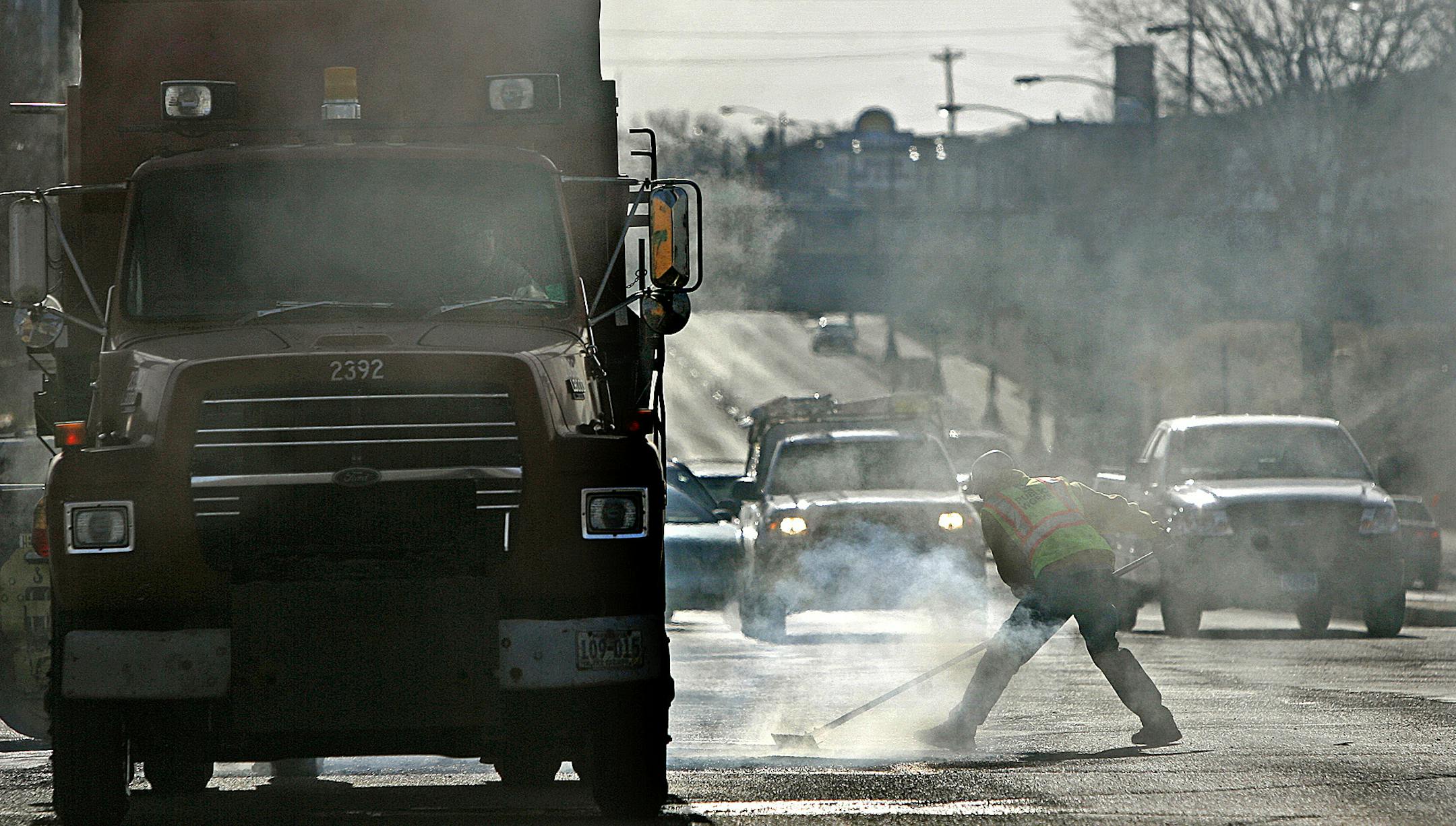 ELIZABETH FLORES • eflores@startribune.com March 24, 2010 - St. Paul, MN - ] IN THIS PHOTO: St. Paul Public Works crew worked on filling pot holes along University Avenue.