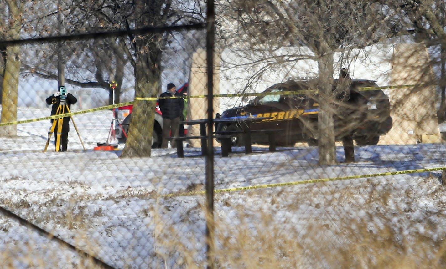 Law enforcement officers investigate the scene of a homicide that took place early Wednesday at a Maple Grove rest area.