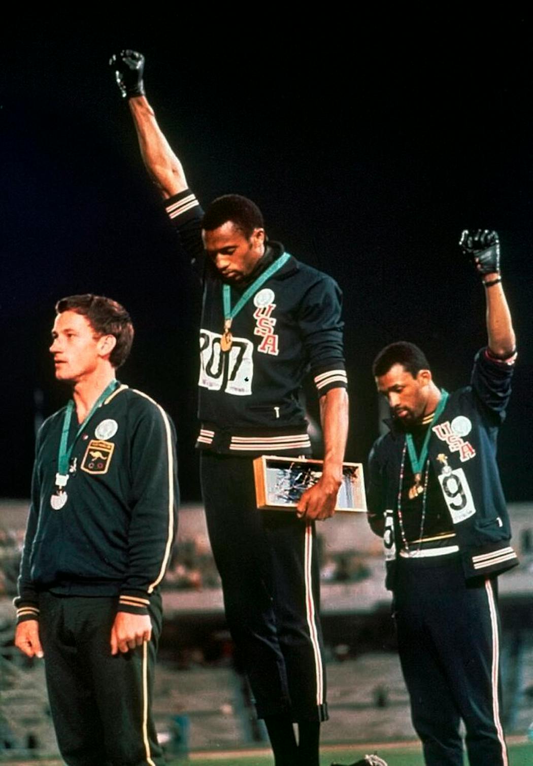 U.S. athletes Tommie Smith, center, and John Carlos protested during the playing of the national anthem after Smith received the gold and Carlos the bronze for the 200-meter run at the Summer Olympic Games in Mexico City on Oct. 16, 1968. Australian silver medalist Peter Norman is at left.