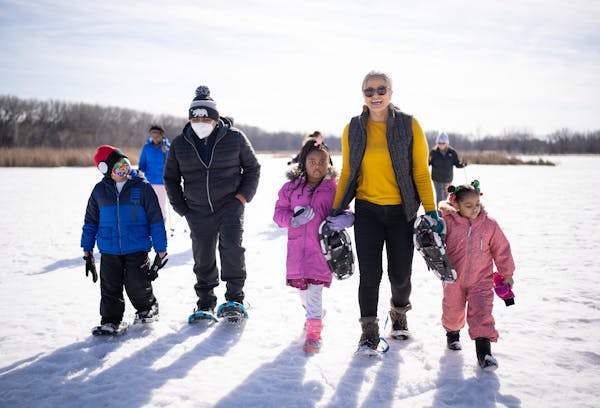 After snowshoeing in the marsh, Richfield Mayor Maria Regan Gonzalez walked back to the nature center with, from left, Ian Acevedo, 7, his dad, Rodolf
