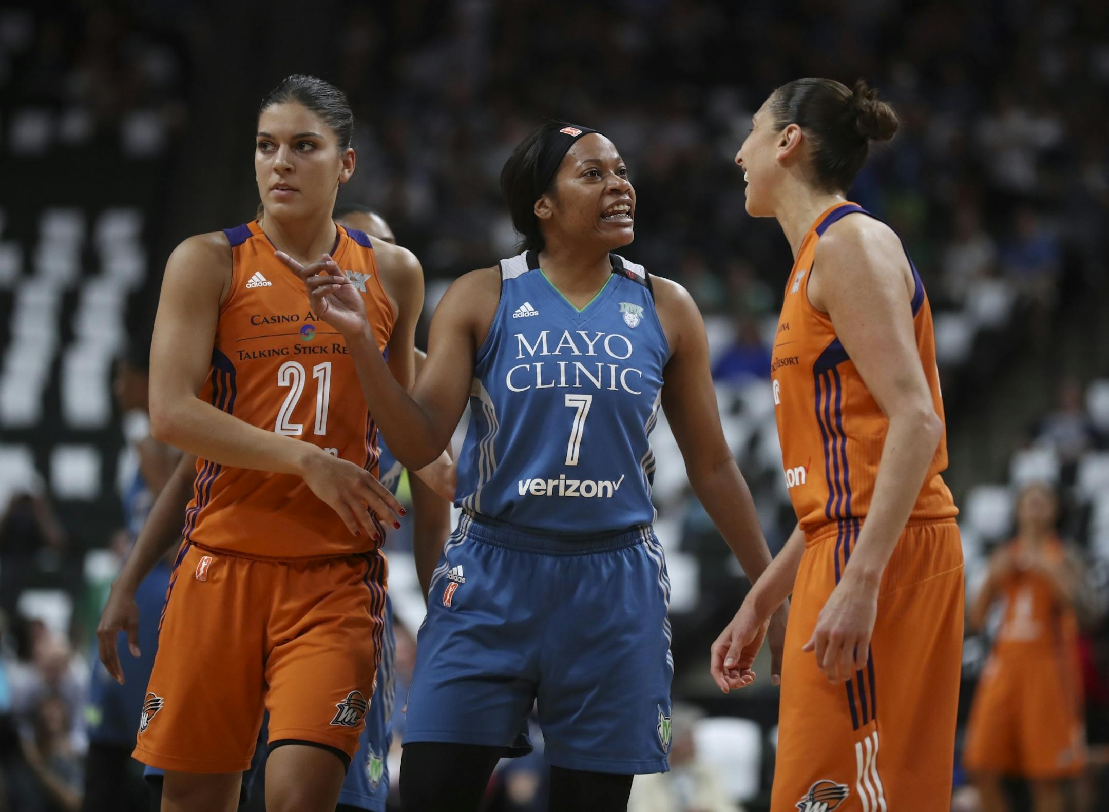 Minnesota Lynx guard Jia Perkins (7) and Phoenix Mercury guard Diana Taurasi (3) rehashed the previous play in the first quarter. At left was Phoenix guard Marta Xargay (21).